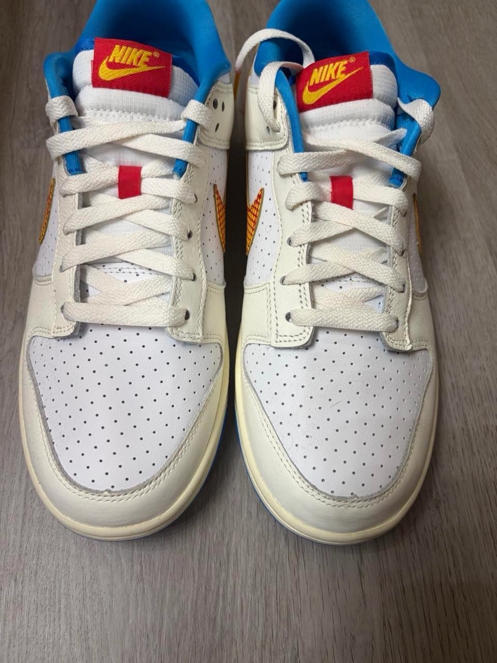 Nike White Dunks with Blue Lining and Red/Yellow Accents